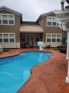 Custom awning over a backdoor leading to a pool